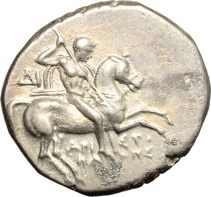 obverse: Italy. Southern Apulia, Tarentum.   AR Nomos, c. 272-240 BC. Obv. Warrior on horseback right, holding shield and two spears, preparing to cast a third; ΔI behind, API-ΣTO/KΛ-HΣ in two lines below. Rev. Phalantos astride, dolphin left, holding kantharos and trident; to right, head of nymph left; below, TAP[AΣ]. HN Italy 1033. Vlasto 877. AR. g. 6.26  mm. 20.50   Enchanting old cabinet tone, with golden and iridescent hues. A few uncleaned, almost invisible, deposits, otherwise EF.