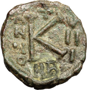 reverse: Heraclius (610-641).  AE Half Follis, Ravenna mint. Obv. [Fragmentary and blundered legend]. Facing busts of Heraclius, Heraclius Constantine and Martina. Rev. Large K between A/N/N/O and V/II/I; beneath, RA. D.O. 293-4. Ranieri 633. Sear 920. AE. g. 3.56  mm. 16.50  RR. Very rare and in excellent condition for issue, perfecly centred and complete. Dark green patina. VF/Good VF. Ex Elsen 91, lot 430.