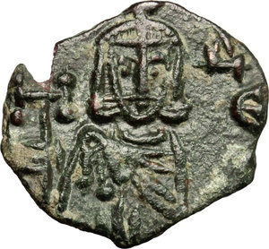 reverse: Constantine V Copronymus with Leo IV (751-775).  AE Follis, Syracuse mint. Obv. Constantine V and Leo IV standing facing, each wearing crown and chlamys and holding akakia; between their heads, cross. Rev. Leo III bearded, standing facing, wearing crown and chlamys and holding cross potent; [to left, Λ/Ε/Ο]; to right, Δ/Ε/C. DOC 19. Sear 1569. AE. g. 1.97  mm. 18.50    Good VF.