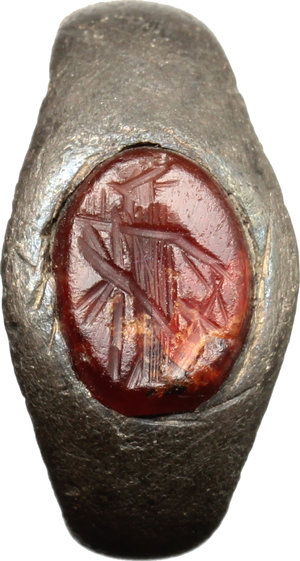 obverse: Silver ring, the bezel decorated carnelian intaglio depicting standing figura holding bunch of grape (Dionysos?).  Roman period, 2nd-3rd century AD.  Size 15.5 mm