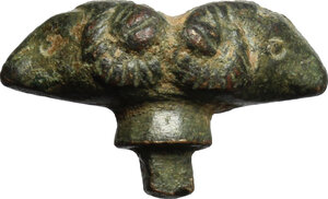 obverse: Bronze applique in shape of two ram-heads back to back.  Roman period, 1st-5th century.  20 mm