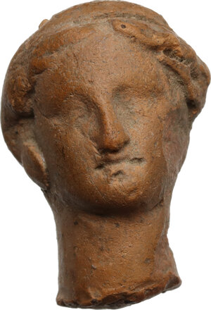 obverse: Terracotta handle fragment in the shape of a female head.  Roman.  25x23x18 mm