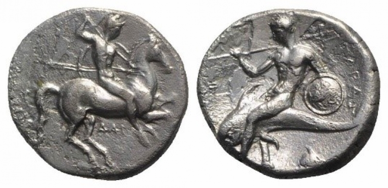 obverse: Apulia, Tarentum (332-302 a.C.). AR Nomos (20mm - 7.60g.). D.\: guerriero a cavallo con scudo e due lance; R.\: Phalanthos con tridente e scudo su delfino - ΦI. Vlasto 596; HNItaly 935. BB. R1.