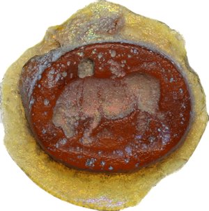 obverse: Glass paste decorated with butting bull.  Roman period, 1st-3rd century AD.  15 mm