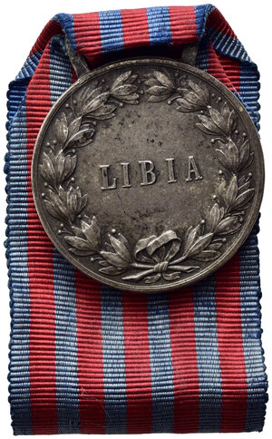 reverse: SAVOIA - Medaglia Guerra di Libia. Argento con nastrino originale, con cambretta, conio privato, peso gr. 15.7,  BB.