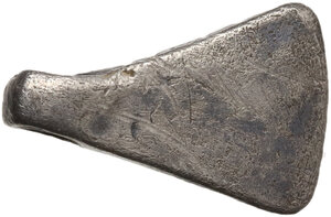 obverse: Silver pendant in the shape of an axe-blade.  20x13 mm