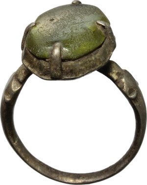 obverse: Silver ring with green glass paste gem.  Medieval period.   Traces of gilding.  21 mm