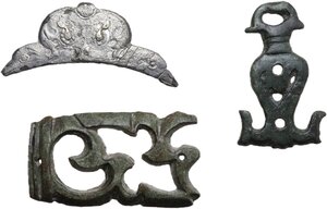 obverse: Roman to Medieval period. Lot of three (3) items, (2) bronze appliqués, probably parts of the decoration of a casket and/or an handle and a silver-gilt decoration, decorated with ornithomorphic and phytomorphic motifs, probably part of the connecting collar between the handle and mouth of a closed-form vessel