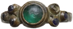 reverse: Medieval or Renaissance period. Bronze ring with circular green stone in the center and three small blue glass pastes on each side.   19 mm