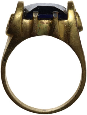 obverse: Post Reinassance, probably 18th century. Gilded ring decorated with two volutes, set with square blue glass gemstone.  16 mm. inner size