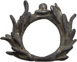 obverse: SILVERED LEAD WREATH  Roman period, c. 1st-3rd century AD.  Silvered lead crown with raised bulla at the intersection of the two laurel branches.  Dimensions: 50x37 mm