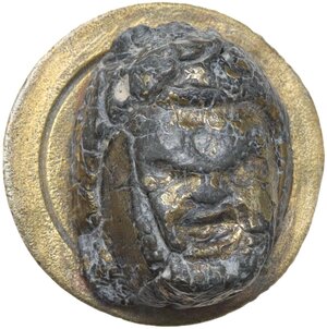 obverse: THEATRE MASK APPLIQUE  Roman period, 1st-3rd century AD.  Roman gilded lead applique configured as a theatre mask seen from the front.  Diameter: 19 mm. Height: 9 mm