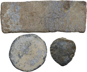 obverse: THREE LEAD ITEMS  Greek and Roman world, c. 3rd century BC-4th century AD.  Lot of three ancient lead items, a bar, a round plaque, a scallop-shell. Letters are visible on the bar.   Dimensions: from 28 to 88 mm