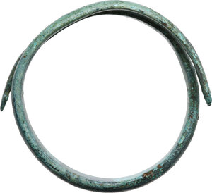 obverse: ETRUSCAN BRONZE ARMILLA  Etruscan, c. 7th century BC.  Etruscan bronze armilla with depiction of two snakes at each end. Details rendered by engraving.  Diameter: 77 mm