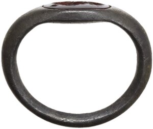 obverse: ROMAN SILVER RING  Roman period, c. 2nd century AD.  Roman silver ring with engraved carnelian. The gemstone depicts a female head (?) turned to the left.  Gem height: 9 mm., Ring size: 15 x 12 mm