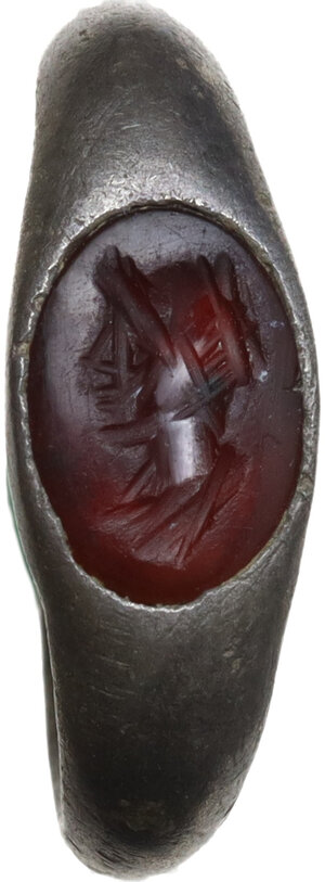 reverse: ROMAN SILVER RING  Roman period, c. 2nd century AD.  Roman silver ring with engraved carnelian. The gemstone depicts a female head (?) turned to the left.  Gem height: 9 mm., Ring size: 15 x 12 mm