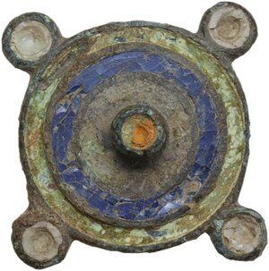 obverse: ROMAN ENAMELLED DISC FIBULA  Roman period, c. 2nd century AD.  Roman bronze fibula in the shape of a disc, with four discs on the circumference and a central relief. Decoration in blue glass paste and bone (?).  Dimensions: 36 mm