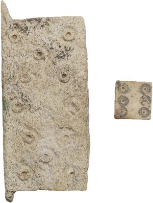 obverse: ROMAN GAMING PIECES  Roman period, c. 1st-3rd century AD.  Lot of two roman bone gaming pieces, comprehending a six faced dice and a rectangular plaque with numeral signs engraved.  Dimensions: 9 and 50 x 21 mm