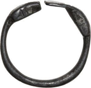 obverse: SILVER SNAKE RING  Roman period (?), c. 1th-3rd century AD.  Ring consisting of a thick cylindrical silver rod, with the two ends configured one as a snake head and one as a flattened tail, both rendered very schematically.  Dimensions: 23 mm., Inner size: 20 mm.  Weight: 4.68 g