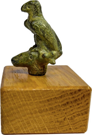 obverse: ROMAN ZOOMORPH FIGURINE  Roman period, c. 1st-3rd century AD.  Roman bronze figurine on wood block (modern addition) depicting an eagle standing on head of a stag.  Figurine dimensions: 33x25x22, wood block: 35x35x20