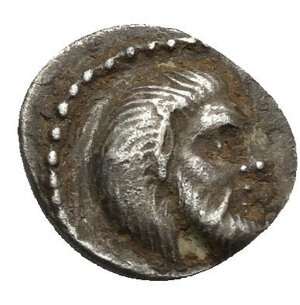 obverse: CILICIA. Nagidos. Circa 400-380 BC. Obol (Silver, 10.45 mm, 0.72 g). Bearded head of Pan to right. Rev. NAΓI Bearded head of Dionysos to right. SNG Levante 4-5. SNG Paris 16-18. Reverse and obverse struck off-centre. Toned, with deposits. About Very Fine.
