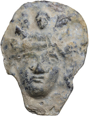 obverse: GODDES LEAD PLAQUE  Roman period, c. 3rd-4th century AD.  Lead plaque depicting the head of a god or goddess with a Victoriola above.   Dimensions: 61x49 mm