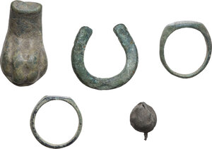obverse: FIVE ROMAN ITEMS  Roman period, c. 1st-5th century AD.  Lot of five roman bronze items, comprehending a miniaturistic horseshoe, a bell, a lion s paw and two rings, one with a dove engraved.  Dimensions: from 38 to 17 mm