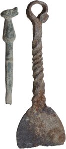 obverse: IRON PADDLE AND BRONZE TOOL  Roman to early Medieval period, c. 1st-10th century AD.  Lot of two items, an iron paddle with a decorated handle and suspension ring and a bronze tool with a duck-shaped end (?).  Paddle lenght: 97 mm., Tool height: 65 mm