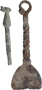 reverse: IRON PADDLE AND BRONZE TOOL  Roman to early Medieval period, c. 1st-10th century AD.  Lot of two items, an iron paddle with a decorated handle and suspension ring and a bronze tool with a duck-shaped end (?).  Paddle lenght: 97 mm., Tool height: 65 mm
