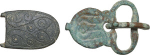 obverse: TWO ANCIENT FIBULAE  Byzantine to Medieval period, c. 7th-12th century AD.  Lot of two ancient bronze fibulae, one Byzantine, the other from the Medieval period.  One with engraved decoration, the other in negative relief.  Dimensions: 50x32 and 34x21 mm