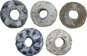 reverse: FIVE LEAD SPINDLE WHORLS  Medieval England, c. 10th-13th century AD.  Lot of five lead Medieval spindle whorls from England, decorated with dots and triangles in relief.  Dimensions: from 31 to 29 mm