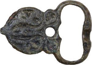 obverse: BYZANTINE FLORAL PATTERN BUCKLE  Byzantine, c. 6th - 7th century AD.  Bronze buckle with floreal pattern.  Dimensions: 44 x 31 mm