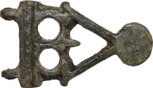 obverse: BYZANTINE BRONZE BUCKLE  Byzantine, c. 8th century AD.  Openwork plate decorated with dot-and-circle indentation, part of a bigger buckle.  Dimensions: 42 x 24 mm