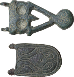 obverse: TWO BYZANTINE FIBULAE  Late Roman period, c. 7th century AD.  Lot of two Byzantine bronze fibulae with engraved decoration.  Dimensions: 51x24 and 37x23 mm