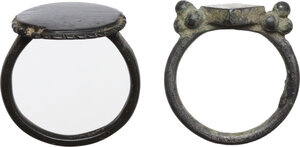 obverse: TWO ANCIENT RINGS  Medieval period, c. 7th - 15th century AD.  Lot of two rings, one in bronze and the other in a silver alloy.  Inner diameters: 18 mm and 19 mm
