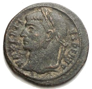 obverse: Maxentius. AD 307-312. Æ Half Follis (21.6 mm, 3.5 g). Ostia mint  Laureate head left / Victory standing right, foot on base of cippus, supporting shield inscribed VOT/XX/FEL in three lines; to left, bound captive seated left, head right. VF.