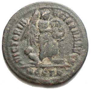 reverse: Maxentius. AD 307-312. Æ Half Follis (21.6 mm, 3.5 g). Ostia mint  Laureate head left / Victory standing right, foot on base of cippus, supporting shield inscribed VOT/XX/FEL in three lines; to left, bound captive seated left, head right. VF.