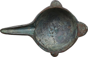 obverse: BRONZE ARAB-BYZANTINE ITEM Byzantine, c. 5th - 10th century AD. Arab-Byzantine oil lamp filler or cosmetic mortar with hemispherical body, deep rounded bowl with three feet, from which extends a long channelled spout, a flat short handle and smaller lateral lugs. Dimensions: 82 x 52 mm