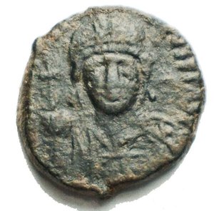 obverse: Justinian I Æ 10 Nummi. Catania(?), dated RY 29 = AD 556/7. D N IVSTINIANVS P P AVC, helmeted and cuirassed bust facing, holding globus cruciger and shield / Large I; ANNO to left, XXVIIII to right; all within wreath. BCI 17 (Catania?); MIBE 229 (Rome); DOC 349 (Ravenna); Sear 326 (Ravenna). 3.76g, 16.01 x 16.68mm Good Very Fine +