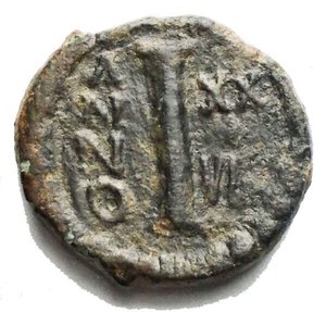 reverse: Justinian I Æ 10 Nummi. Catania(?), dated RY 29 = AD 556/7. D N IVSTINIANVS P P AVC, helmeted and cuirassed bust facing, holding globus cruciger and shield / Large I; ANNO to left, XXVIIII to right; all within wreath. BCI 17 (Catania?); MIBE 229 (Rome); DOC 349 (Ravenna); Sear 326 (Ravenna). 3.76g, 16.01 x 16.68mm Good Very Fine +