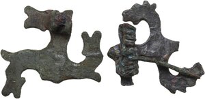 reverse: TWO ROMAN BRONZE SWASTIKA FIBULAE Roman period, Balkan area, c. 3rd-4th century AD. Lot of two roman bronze swastika fibulae with the depiction of a stylised horse s head on each arm of the hooked cross. Dimensions: both 36 mm