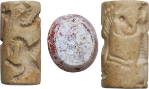 obverse: TWO CYLINDER SEALS AND A CABOCHON. Modern revivals. Lot of two stone cylinder seals both depicting hunting scenes and a carnelian cabochon depicting a seated woman with a chalice. Heights: 36, 35 and 24 mm. Width: 19, 16.5 and 21 mm