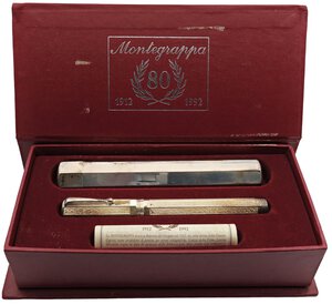 obverse: MONTEGRAPPA.  Edizione commemorativa per 80° Anniversario della fonazione dell’azienda, prodotta nel 1992 -Penna Stilografica- Edizione limitata 1912 esemplari. Corpo e cappuccio in argento massiccio 925. Ricarica a cartuccia/converter. Pennino in oro bianco 18kt. Penna nuova, mai inchiostrata né provata, venduta con tutto il suo corredo completo compreso porta penne rigido e certificato di garanzia.. n.d.