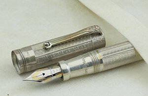 reverse: MONTEGRAPPA Lancaster -Penna Stilografica-. Corpo e cappuccio in argento massiccio 925 a ricami floreali. Ricarica a cartuccia/converter. Pennino EF in oro bianco 18kt. Penna nuova, mai inchiostrata né provata, venduta con tutto il suo corredo completo (da notare la bellissima scatola in legno).. n.d.