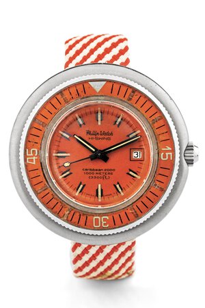 obverse: Philip Watch Caribbean 2000, anni 70 Cassa rotonda in acciaio, ghiera girevole in acciaio, lunetta arancione in bakelite. Quadrante arancione, indici luminescenti. Movimento a carica automatica. Cinturino in tessuto. Dimensioni: 50 mm.